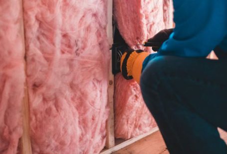Insulate - Unrecognizable worker insulating with stone wool