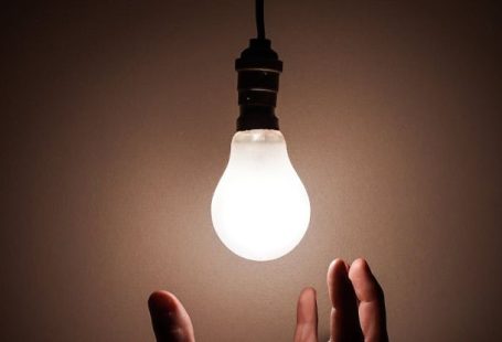 Electrical Outage - Person Holding White Light Bulb